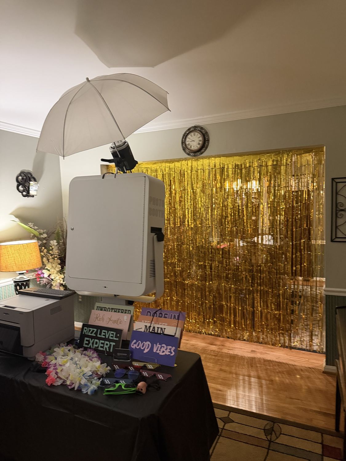 Photo booth with a gold fringe curtain in a family home