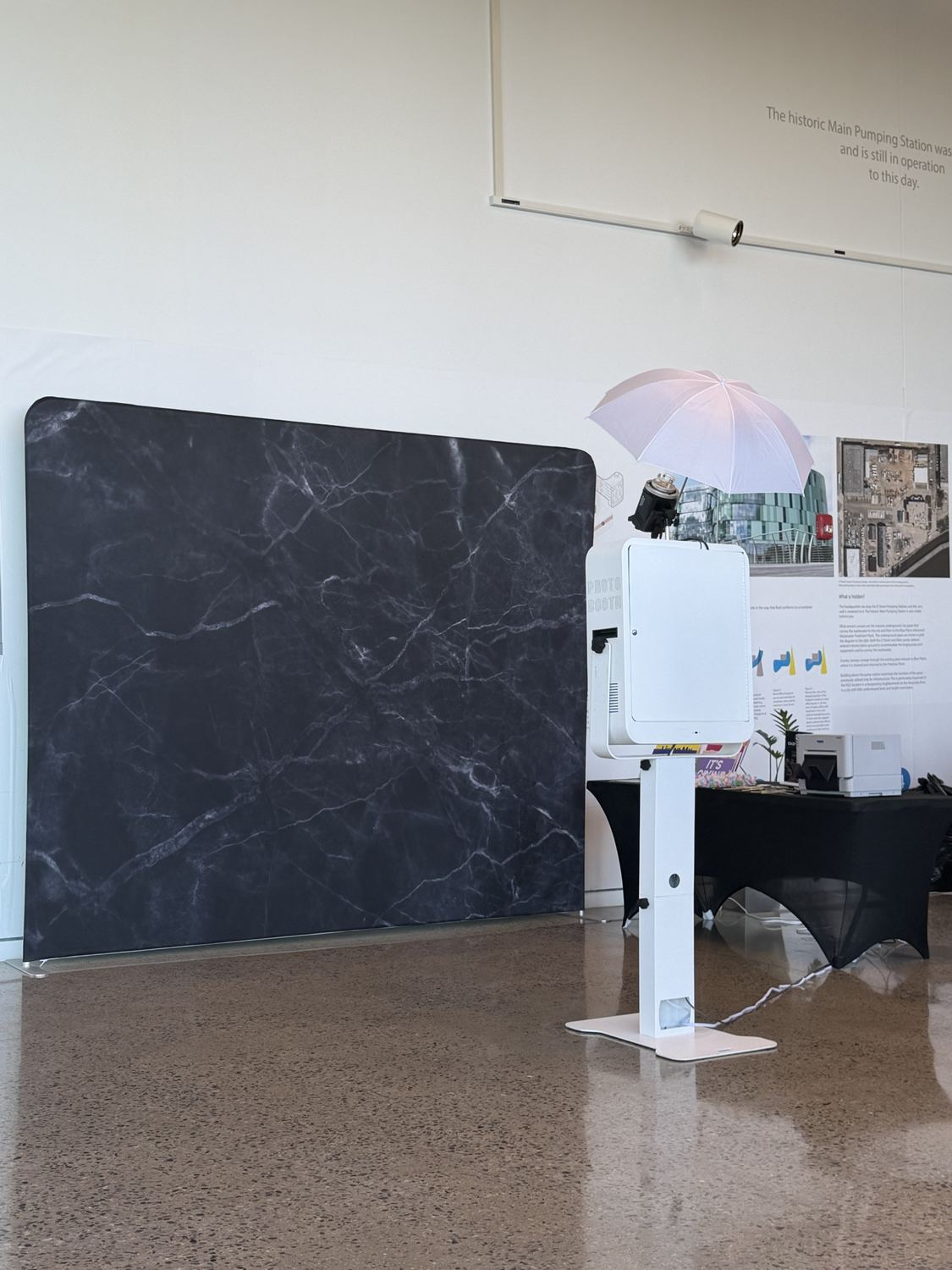 Photo booth beside a black marble backdrop in an open lobby